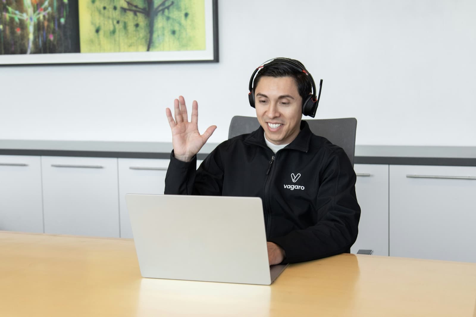 A team member waving hello on a video call